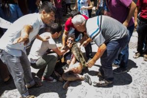 epa04854185 People try to help wounded people after an explosion at a cultural center in Suruc, Sanliurfa province, Turkey, 20 July 2015. At least 20 people were killed and some 100 wounded in a suicide blast ouside a cultural centre in Suruc, Sanliurfa province. The incident took place in Suruc, across from northern Syria town Kobane, which was the scene of heavy battles earlier this year between Kurdish fighters, backed by United States-led airstrikes, and the Islamic State extremist group. Nearlt at the same time, casualties were reported in a car bombing in Kobane near a checkpoint close to the Syrian-Turkish border.  EPA/DEPO PHOTOS ATTENTION EDITORS: PICTURE CONTAINS GRAPHIC CONTENT ; TURKEY OUT