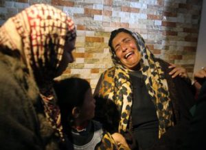 epa04510831 The mother (R, no name given) of suspected Palestinian attacker Amal Taqatqa is crying in her home in the West Bank village of Fajar, south of Bethlehem, 01 December 2014 after she learned her daughter had been shot and seriously wounded by an Israeli soldier after Amal allegedly had stabbed an Israeli at the Gush Etzion interchange in the West Bank, not far from the village. Israeli forces ransacked the house of Amal Taqatqa after the attack.  EPA/ABED AL HASHLAMOUN