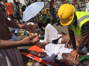 In this image posted on the official Twitter account of the directorate of the Saudi Civil Defense agency, a pilgrim is treated by a medic after a stampede that killed and injured pilgrims in the holy city of Mina during the annual hajj pilgrimage on Thursday, Sept. 24, 2015. (Directorate of the Saudi Civil Defense agency via AP) MANDATORY CREDIT
