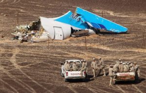 In this photo made available Monday, Nov. 2, 2015, and provided by Russian Emergency Situations Ministry, Egyptian Military on cars approach a plane's tail at the wreckage of a passenger jet bound for St. Petersburg in Russia that crashed in Hassana, Egypt, on Sunday, Nov. 1, 2015. The Russian cargo plane on Monday brought the first bodies of Russian victims killed in a plane crash in Egypt home to St. Petersburg, a city awash in grief for its missing residents. (Maxim Grigoriev/Russian Ministry for Emergency Situations via AP)