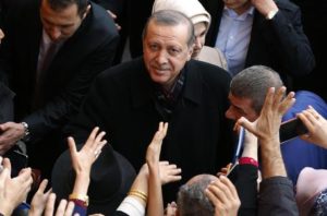 Turkey's President Recep Tayyip Erdogan, centre, looks up as he leaves a polling station, in Istanbul, Sunday, Nov. 1, 2015. Turks headed to the polls Sunday for the second time in five months in what is being seen as a crucial general election that will determine whether the ruling party can restore the parliamentary majority it enjoyed for the past 13-years. (ANSA/AP Photo/Emrah Gurel)