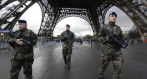 TOPSHOTS French soldiers patrol in front of the Eiffel Tower on January 8, 2015 in Paris as the capital was placed under the highest alert status a day after heavily armed gunmen shouting Islamist slogans stormed French satirical newspaper Charlie Hebdo and shot dead at least 12 people in the deadliest attack in France in four decades. A huge manhunt for two brothers suspected of massacring 12 people in an Islamist attack at a satirical French weekly zeroed in on a northern town Thursday after the discovery of one of the getaway cars. As thousands of police tightened their net, the country marked a rare national day of mourning for Wednesday's bloodbath at Charlie Hebdo magazine in Paris, the worst terrorist attack in France for half a century. AFP PHOTO / BERTRAND GUAYBERTRAND GUAY/AFP/Getty Images