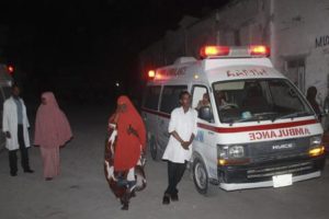 epa05116774 Ambulance workers stand by near the Lido beach where gunmen exploded a car bomb and opened fire at a restaurant in Mogadishu, Somalia, 21 January 2016. Reports say that Somali security are still battling the attackers and it is unclear who is behind the attack on Mogadishu's popular beach. EPA/SAID YUSUF WARSAME