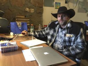 Ammon Bundy sits at a desk he's using at the Malheur National Wildlife Refuge in Oregon on Friday, Jan. 22, 2016. Bundy is the leader of an armed group occupying a national wildlife refuge to protest federal land policies. The leader of an armed group occupying the refuge met briefly with a federal agent Friday, but left because the agent wouldn't talk with him in front of the media. (ANSA/AP Photo/Keith Ridler)