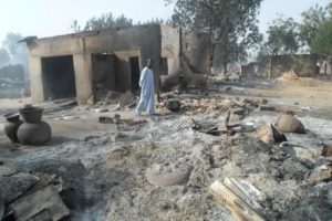 A man walks past burnt out houses following an attack by Boko Haram in Dalori village 5 kilometers (3 miles) from Maiduguri, Nigeria, Sunday Jan. 31, 2016. A survivor hidden in a tree says he watched Boko Haram extremists firebomb huts and listened to the screams of children among people burned to death in the latest attack by Nigeria s homegrown Islamic extremists. (ANSA/AP Photo/Jossy Ola)