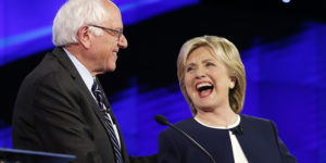 Sen. Bernie Sanders, of Vermont,, left, and Hillary Rodham Clinton laugh during the CNN Democratic presidential debate, Tuesday, Oct. 13, 2015, in Las Vegas. (AP Photo/John Locher)