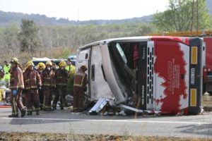 epa05222061 Firemen work at the site of a coach crash that has left at least 14 students dead at the AP-7 motorway in Freginals, in the province of Tarragona, northeastern Spain, 20 March 2016. The coach carrying dozens of Erasmus students collided with a car and overturned. The students from several different countries were heading to Barcelona after attending Las Fallas Festival in Valencia, eastern Spain. EPA/JAUME SELLART