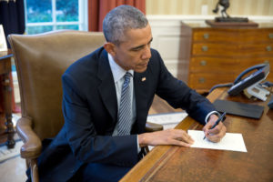 President Barack Obama signs a letter to a Cuban letter writer, in the Oval Office, March 14, 2016. (Official White House Photo by Pete Souza)