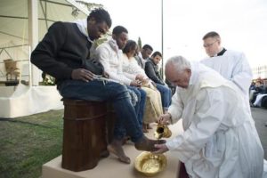 Pope Francis washes the foot of a man during the foot-washing ritual at the Castelnuovo di Porto refugees center, some 30km (18, 6 miles) from Rome, Thursday, March 24, 2016. The pontiff washed and kissed the feet of Muslim, Orthodox, Hindu and Catholic refugees Thursday, declaring them children of the same God, in a gesture of welcome and brotherhood at a time when anti-Muslim and anti-immigrant sentiment has spiked following the Brussels attacks. (L'Osservatore Romano/Pool Photo via AP)