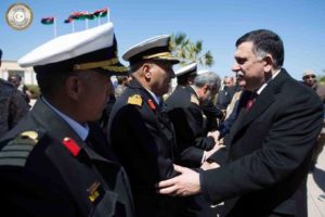 epa05236775 A handout photograph made available by Media office of the Unity Government (GNA MEDIA) shows Fayez Serraj (R) from the UN brokered Libyan unity government being greeted by unidentified officials upon his arrival in Tripoli, Libya, 30 March 2016. EPA/GNA MEDIA / HANDOUT HANDOUT EDITORIAL USE ONLY/NO SALES