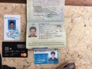 FILE -- In this file photo released by the Egyptian Ministry of Interior on Thursday, Mar. 24, 2016, personal belongings of slain Italian graduate student Giulio Regeni, including his passport, are displayed. On Sunday, April 3, 2016 the editor of Egypt's top state newspaper called on Egyptian authorities to seriously deal with the case of an Italian student tortured and killed in Cairo, saying officials who didn't realize the gravity of the case are risking Egyptian-Italian relations. Italian Premier Matteo Renzi has insisted Italy will settle for nothing less than the truth. (Egyptian Interior Ministry via AP, File)