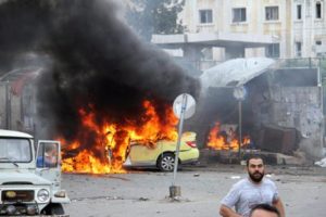 epa05324728 A handout photograph released by the official Syrian Arab News Agency (SANA) shows flames rising following a bombing at a bus station in the coastal city of Tartus, Syria, 23 May 2016. According to SANA, at least 20 people were killed in three bombings targeting bus station and a residential suburb in front of the bus station in Tartous. Some 45 people were also killed in a series of bombings in Jableh city. EPA/SANA HANDOUT HANDOUT EDITORIAL USE ONLY/NO SALES