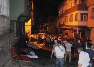 People gather after an explosion in Gaziantep, southeastern Turkey, early Sunday, Aug. 21, 2016. Gaziantep Province Gov. Ali Yerlikaya said the deadly blast, during a wedding near the border with Syria, was a terror attack. (Eyyup Burun/DHA via AP)e [CopyrightNotice: DHA]