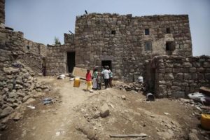 In this July, 25, 2016 photo, relatives of 10-year-old Youssef al-Salmi, who was killed when a bomb exploded while he was playing with it, play in front his house, in Hasn Faj Attan village, on the mountainous outskirts of Sanaa, Yemen. The village lies near a military base that housed a vast arsenal and Saudi-led airstrikes on the base caused a series of powerful explosions in April 2015. Rights groups and U.N. agencies have expressed concern that even if the fighting is brought to an end, the country will still grapple with a brutal legacy of unexploded munitions. (ANSA/AP Photo/Hani Mohammed) [CopyrightNotice: Copyright 2016 The Associated Press. All rights reserved. This material may not be published, broadcast, rewritten or redistribu]