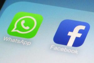 FILE - This Feb. 19, 2014, file photo, shows WhatsApp and Facebook app icons on a smartphone in New York. WhatsApp says on Tuesday, April 5, 2016,  it's now using a powerful form of encryption to protect the security of photos, videos, group chats and voice calls in addition to text messages sent by more than a billion users around the globe. (ANSA/AP Photo/Patrick Sison, File)