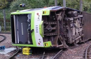 A photo issued by the Rail Accident Investigation Branch of the tram which derailed near the Sandilands stop in Croydon, London, Wednesday, Nov. 9, 2016. Several people were killed and more than 50 injured when a tram derailed in south London during a heavy rainstorm before dawn Wednesday, police said. Emergency workers worked for hours to free five people trapped in the wreckage of the two-carriage tram that tipped on its side next to an underpass. (RAIB via AP)