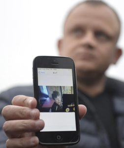 Ariel Zurawski, the owner of a Polish trucking company, shows the last photo taken of his cousin and driver, Lukasz Urban, who was apparently the first victim of the attack in Berlin on Monday, in Sobiemysl, Poland, on Tuesday, Dec. 20, 2016. The attacker apparently hijacked Urban's truck and stabbed and shot the Poles to death before driving the truck into the Christmas market.(ANSA/AP Photo) [CopyrightNotice: Copyright 2016 The Associated Press. All rights reserved.]