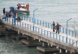 epa05687865 Rescuers unload fragments and remains from a boat, found at the site of the Tu-154 plane crash near Sochi, Russia, 25 December 2016. According to media reports, a Tupolev-154 Russian airplane carrying at least 92 people disappeared from radar and crashed into the Black Sea after taking off from an airport in Sochi on 25 December. The plane which was flying to Latakia, Syria, was reportedly carrying 65 members of the Alexandrov Ensemble, eight crew members, nine Russian journalists as well as Russian civil activist, Doctor Yelizaveta Glinka (Doctor Liza). EPA/YEVGENY REUTOV