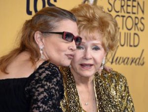 epa05690440 (FILE) - A file picture dated 25 January 2015 shows US actresses Debbie Reynolds (R) and her late daughter Carrie Fisher (L) posing at the 21th Annual Screen Actors Guild Awards ceremony at the Shrine Auditorium in Los Angeles, California, USA. According to media reports on 28 December 2016, US actresses Debbie Reynolds died at the age of 84 at a hospital in Los Angeles on 28 December, one day after her daughter Carrie Fisher, known for her Princess Leia role in Star Wars series, died after suffering a heart attack. EPA/PAUL BUCK