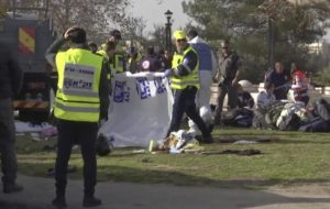 This frame grab from video, shows Israeli emergency services personnel covering bodies with plastic sheets at scene of a truck-ramming attack in Jerusalem that killed at least four people and wounded several others in Jerusalem, Sunday, Jan. 8, 2017. Israeli police and rescue services said a Palestinian rammed his truck into a group of Israeli soldiers in one of the deadliest attacks of a more than yearlong campaign of violence. Security camera footage shows the truck barreling at a high speed off the road and into a crowd of people in the Armon Hanatziv neighborhood. (ANSA/AP Photo) [CopyrightNotice: Copyright 2017 The Associated Press. All rights reserved.]